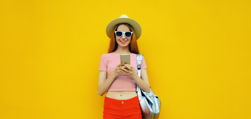 Summer portrait of happy traveler young woman 20s with mobile phone looking at device