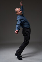 Businessman about to fall over, isolated on gray