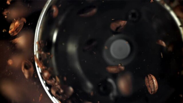 Coffee beans in a working grinder. Filmed on a high-speed camera at 1000 fps. High quality FullHD footage