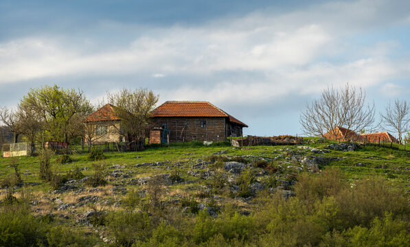 A mountain country house on top of a hill. Mountain village household. landscape photo of a country house.