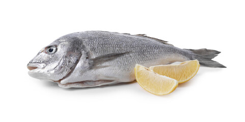 Raw dorado fish and lemon wedges isolated on white
