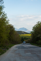 
Old winding mountain road. Mountain peaks can be seen in the background.
Country road in the Serbian mountains.