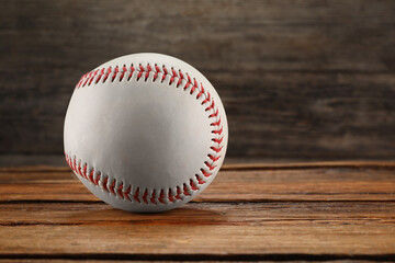 Baseball ball on wooden background, space for text