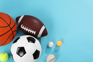 Many different sports balls on light blue background, flat lay. Space for text