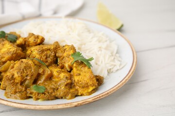 Delicious chicken curry with rice on white wooden table