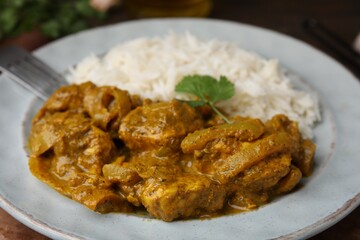 Delicious chicken curry with rice on table, closeup