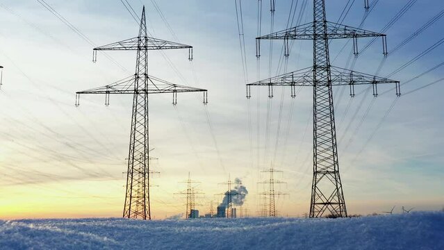 High-voltage power lines in Winter in front of a coal-fired power plant, Germany