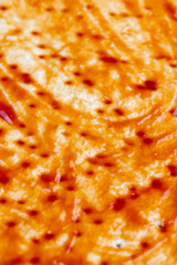 pizza dough with red ketchup and spices