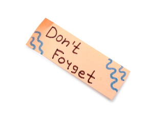 Sticky note with text DON'T FORGET on white background
