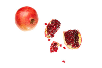 Flying fresh pomegranates with seeds on white background