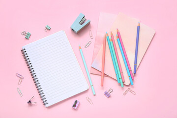 Many colorful pencils with stationery on pink background