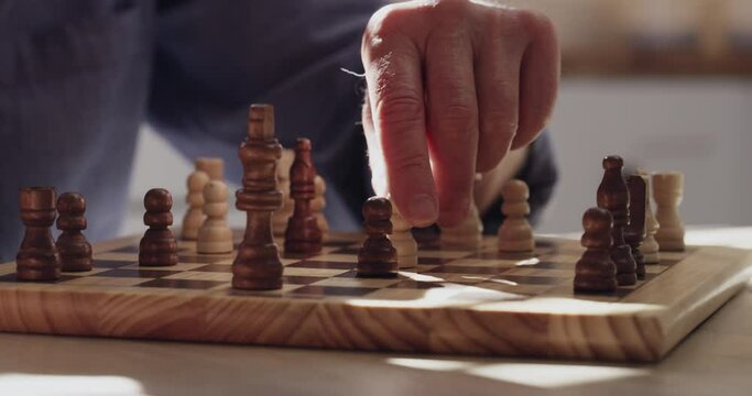 Hands, couple and playing chess together at home, challenge and bonding for relationship. Chessboard, closeup and competition or problem solving for game plan, activity and contest for relaxing