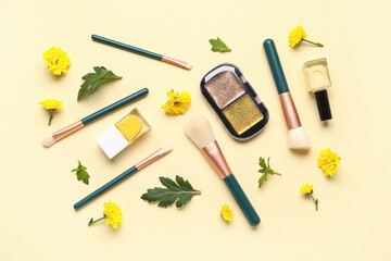 Composition with makeup products and beautiful chrysanthemum flowers on beige background