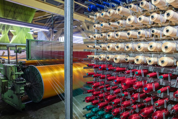Synthetic yarns for carpet factory, carpet production, weaving looms. Interior of a Carpet Weaving...