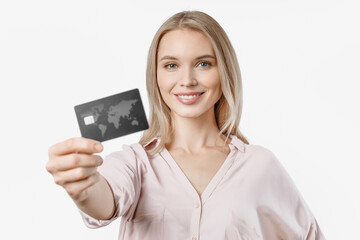 Cheerful young woman showing credit card isolated over white background. Online purchase shopping buying presents gifts e-banking concept