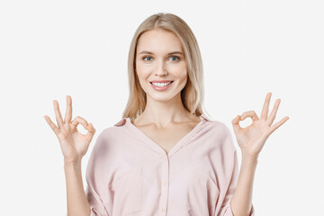 Happy woman in casual showing OK gesture isolated on white background. Positive emotion of confirmation accepted approved concept