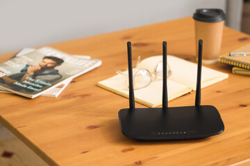 Modern wi-fi router on table in living room, closeup