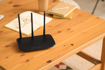 Modern wi-fi router on table in living room, closeup