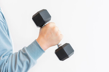 Male hand holding an iron black dumbbell on white background, copy space.