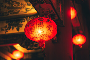 Red Chinese lantern(Translation Hieroglyph text Happy New Year) hanging in a row during day time for Chinese new year celebration. © Charnchai saeheng