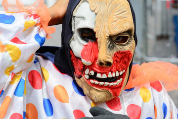 A person with a horror mask parading in the carnival