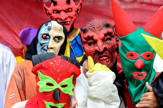 Group Of People Dressed In Horror Costumes Against Red Background