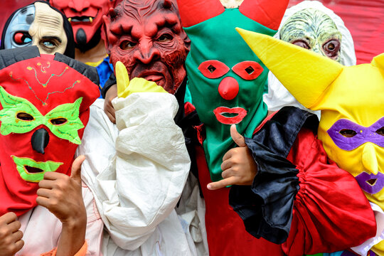 Group Of People Dressed In Horror Costumes Against Red Background