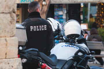 Hellenic Police with "Greek Police" logo emblem on uniform, Greek police squad on duty maintain public order in the streets of Athens, Attica, Greece, group of policemen