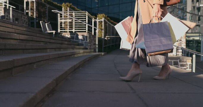 Walking, stairs and woman with shopping bags in the city for sale, discount or promotion. Fashion, steps and closeup of female person with elegant, classy or fancy style commuting in urban town.