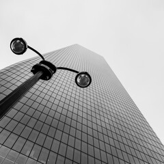 modern building clock with street lamp in the fog