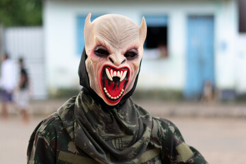 An unidentified person is wearing a horror costume and mask in the Acupe district in the city of...