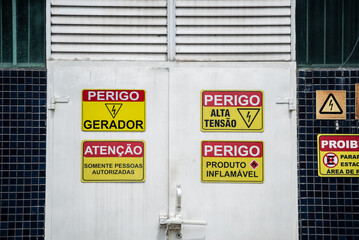 Sign indicating that there is high voltage energy and flammable product. Commercial District in the...