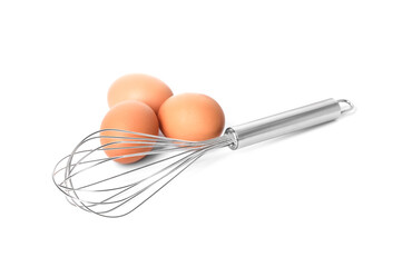 Metal whisk and raw eggs isolated on white