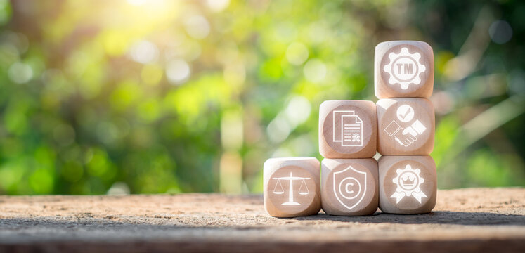 Trademark concept, Wooden block on desk with trademark icon on virtual screen. Brand, Copyright Protection, Marketing, Legal, Ownership, Label, Registration, Patent.