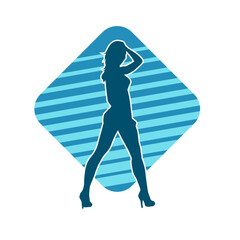 Silhouette of a young slim female model in tight outfit. Silhouette of a slim woman in feminine pose.