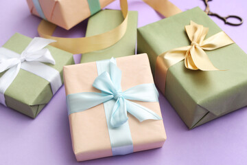 Fototapeta na wymiar Gift boxes and ribbon on purple background. International Women's Day