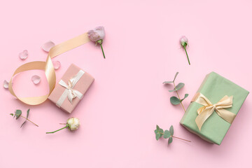 Gift boxes with beautiful roses and petals on pink background. International Women's Day