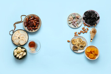Composition with different Eastern sweets, Aladdin lamp and tasbih for Ramadan on color background