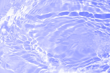 Water surface. Bluewater waves on the surface ripples blurred. Defocus blurred transparent blue colored clear calm water surface texture with splash and bubbles. Water waves with shining pattern.