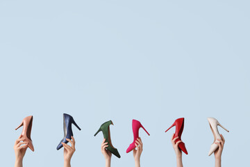 Women with stylish heels on light background