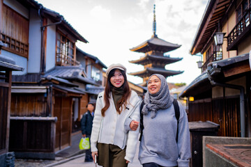 Travel, muslim travel,  woman girl tourist Two Asian friends but different religions walking at...