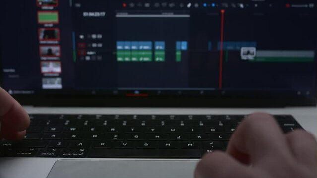 Monitor or display of the editor's laptop. Uses a computer to creatively create a video clip. Makes color correction of video content. A freelance colorist works at home in the studio. Cinematographer