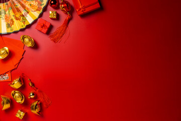 Chinese New Year ambiance through this top-view arrangement featuring fans, Feng Shui items,...