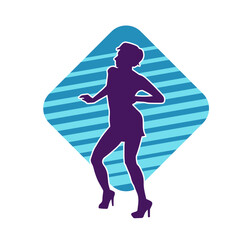 Silhouette of a female dancer wearing mini skirt in action pose. Silhouette of a slim woman dancing happily.