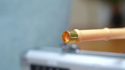 Close-up capturing the dynamic motion of a red dart in mid-flight with a blurred background potentially loaded with a tranquilizer or poison