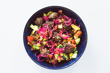 plant-based falafel nourish bowl salad with avocado tomato cucmber and pickled onion