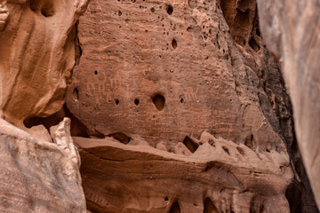 Ancient inscriptions of the Nabataean civilization made on the rock of the city of Hegra in Al Ula.