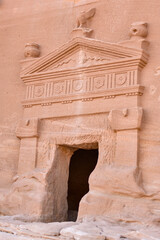 Entrance to a tomb carved into the rock in the Hegra archaeological park of the city of Al Ula.