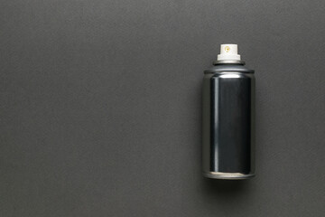 An aerosol can with grease on a gray background with space for copying.