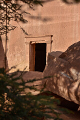 Entrance to a tomb carved into the rock in the Hegra archaeological park of the city of Al Ula.